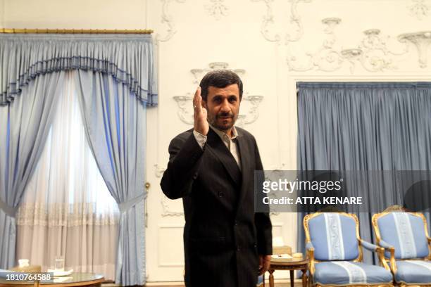 Iranian President Mahmoud Ahmadinejad waves to the media prior to a meeting at the presidency in Tehran, on May 18, 2010. Iranian officials said that...