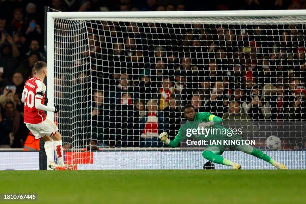 Arsenal's Italian midfielder Jorginho scores his team's sixth goal from a penalty past Lens' French goalkeeper Brice Samba during the UEFA Champions...