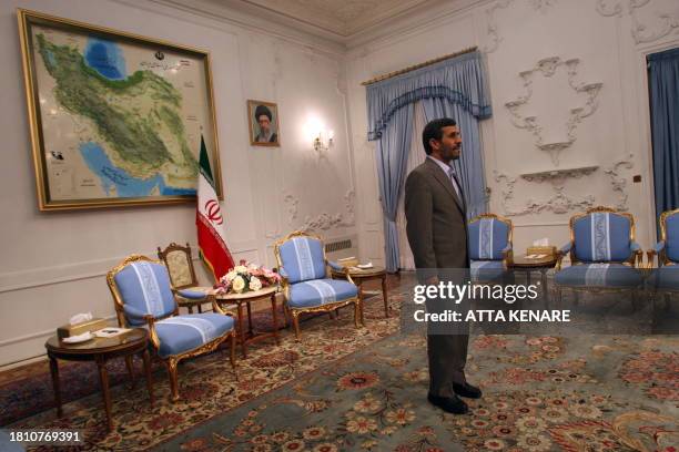 Iranian President Mahmoud Ahmadinejad waits for Iraqi parliament speaker Iyad al-Samarrai before their meeting at the presidential offices in Tehran...