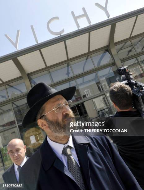 French chief rabbi Gilles Bernheim , flanked by Vichy's mayor Claude Malhuret , arrives at Vichy train station on April 25, 2010 for a visit to mark...