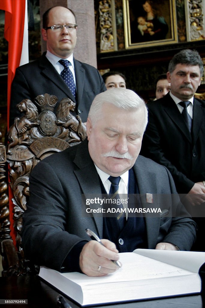 Polands former president Lech Walesa signs the book of condolences Polands former president Lech Walesa signs the book of condolences