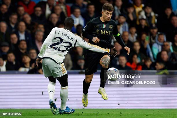 Real Madrid's French defender Ferland Mendy vies with Napoli's Italian defender Giovanni Di Lorenzo during the UEFA Champions League first round...