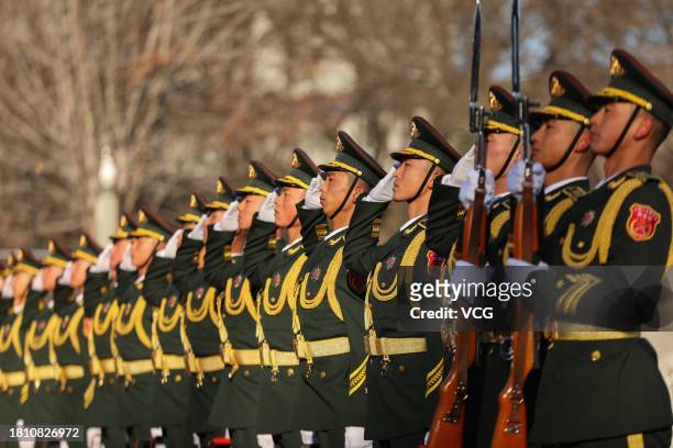 Chinese honour guards salute during a burial ceremony for the remains of 25 Chinese soldiers who died during the Korean War at the Chinese People's...