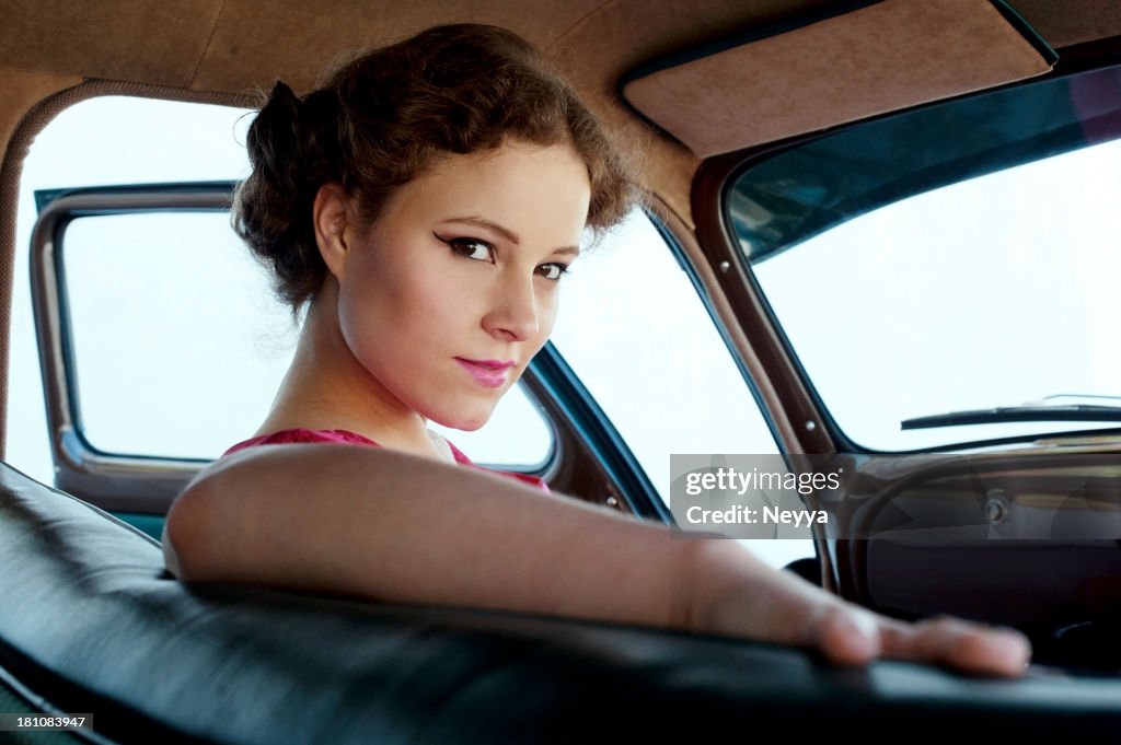 Femme dans une voiture ancienne 1950-1960 Style