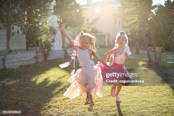 two little girls having fun and running together - sister stock pictures, royalty-free photos & images