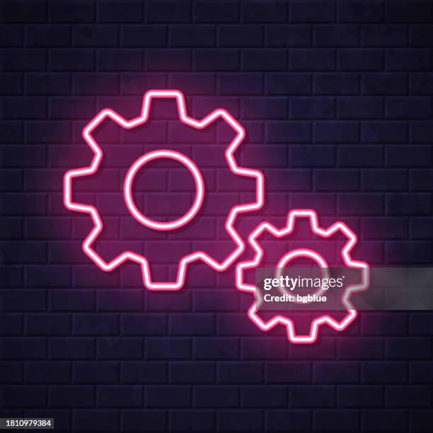 gears - settings. glowing neon icon on brick wall background - spinning wheel stock illustrations