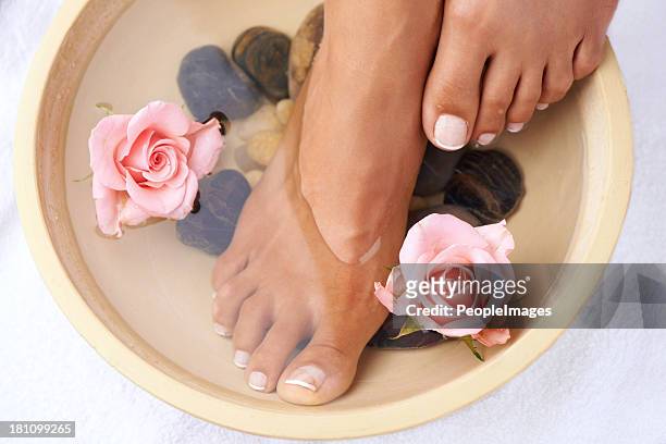 soaking in nature's goodness - foot spa stock pictures, royalty-free photos & images