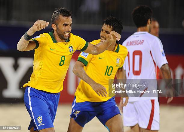 Bruno Xavier of Brazil celebrates with Jorginho after scoring during the FIFA Beach Soccer World Cup Tahiti 2013 Group C match between Brazil and...
