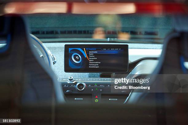 Monitor screen displays the multimedia entertainment system on the dashboard of a BMW i3 battery-powered automobile, manufactured by Bayerische...