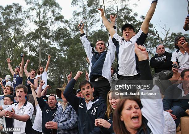 Seville supporters sitting on a couch on the back of a ute celebrate after their team kicked a goal during the Yarra Valley Mountain District...