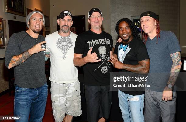 Guitarists Clint Lowery and John Connolly, bassist Vince Hornsby, singer Lajon Witherspoon and drummer Morgan Rose of Sevendust pose after performing...