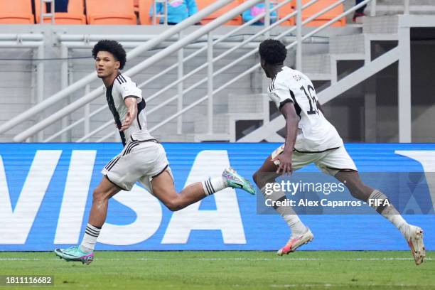 Paris Brunner of Germany celebrates with teammate Winners Osawe after scoring the team's first goal from the penalty spot during the FIFA U-17 World...