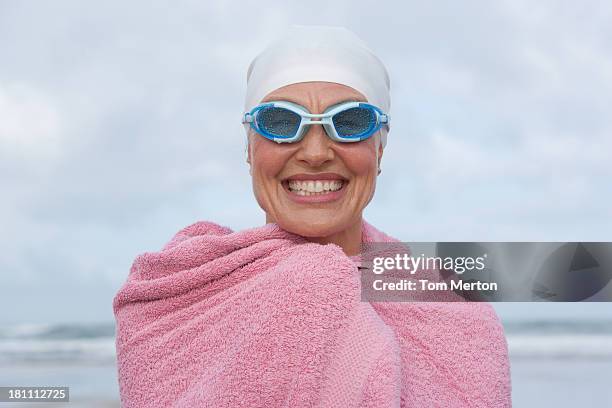 woman at the beach wrapped in a towel - goggles stock pictures, royalty-free photos & images