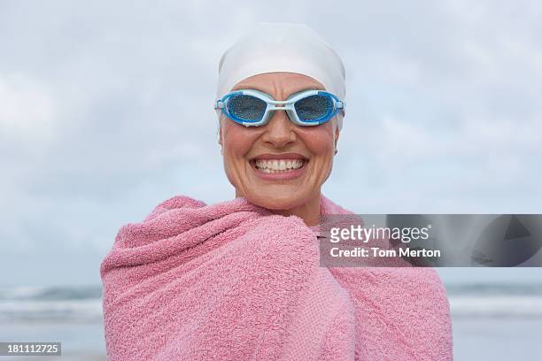 woman at the beach wrapped in a towel - simglasögon bildbanksfoton och bilder