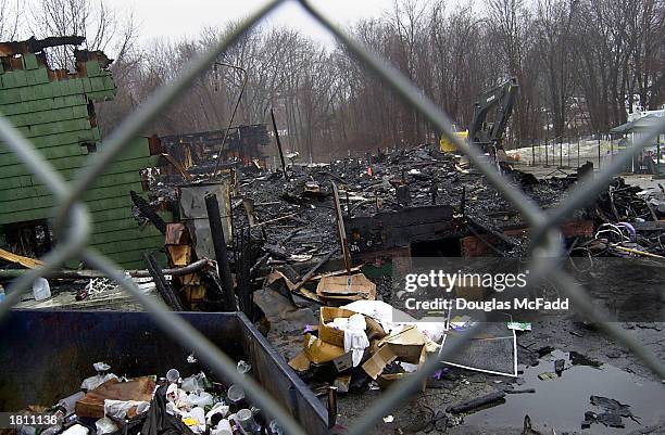 The burned remnants of "The Station" nightclub litters the scene February 23, 2003 in West Warwick, Rhode Island. A deadly fire, that took the lives...