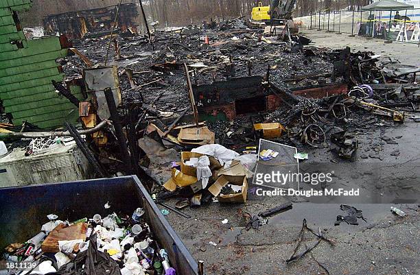 The burned remnants of "The Station" nightclub litters the scene February 23, 2003 in West Warwick, Rhode Island. A deadly fire, that took the lives...