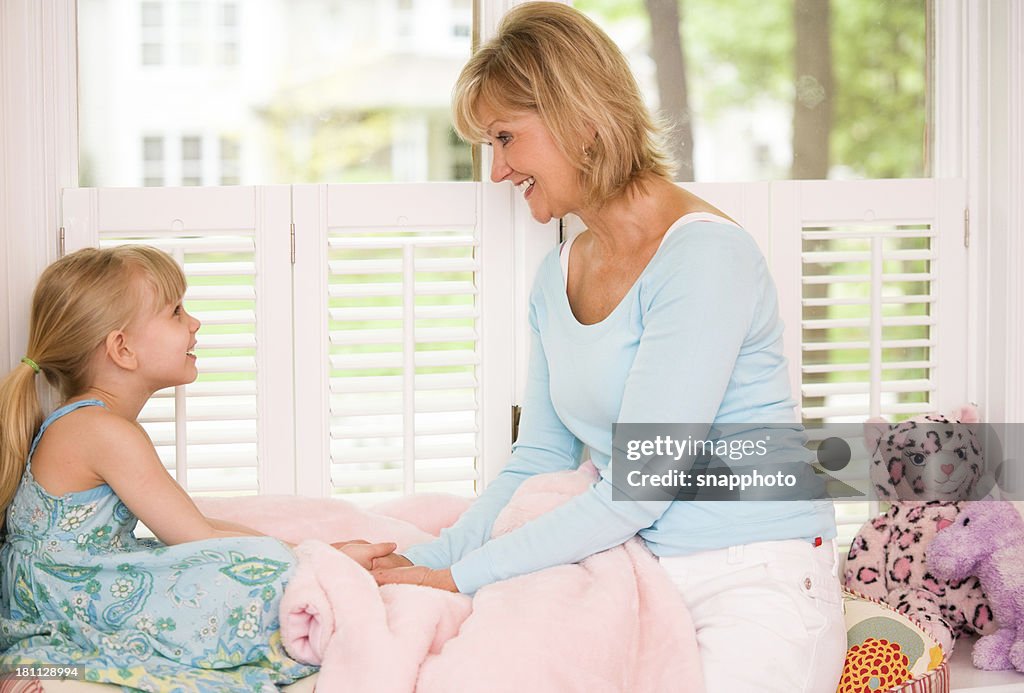 Child and Woman Talking on Window Seat