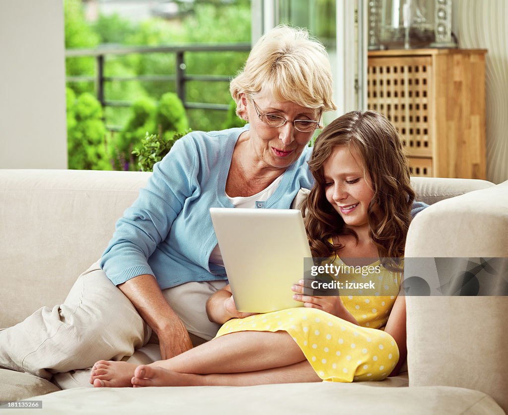 Grandma and granddaughter with digital tablet