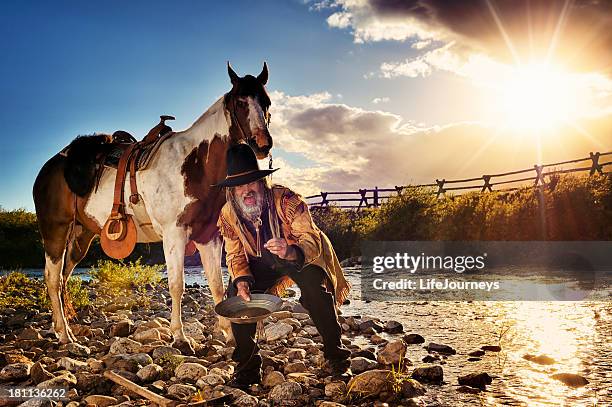 prospector striking it rich while panning for gold - gold rush stock pictures, royalty-free photos & images