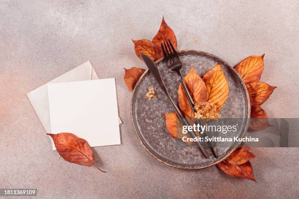 autumn table setting with empty card and dry autumn leaves - empty plate stock pictures, royalty-free photos & images
