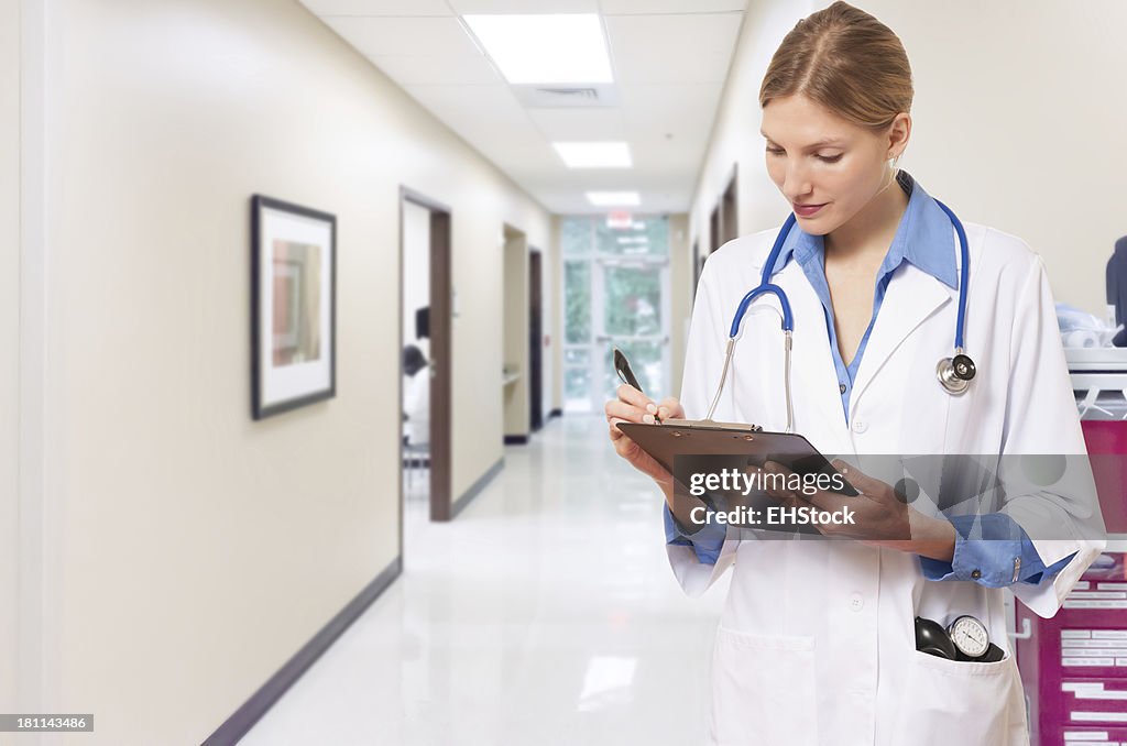 Young Woman Doctor Nurse with Clipboard in Hospital Clinic
