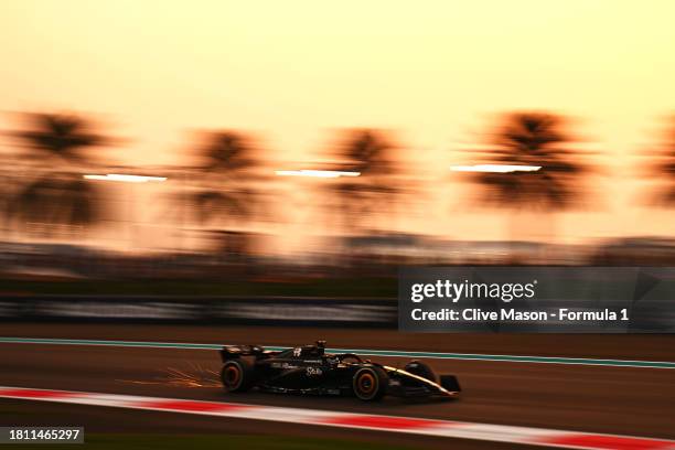 Sparks fly behind Valtteri Bottas of Finland driving the Alfa Romeo F1 C43 Ferrari on track during practice ahead of the F1 Grand Prix of Abu Dhabi...