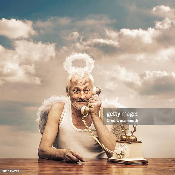 senior angel holding telephone receiver - crazy white hair stock pictures, royalty-free photos & images