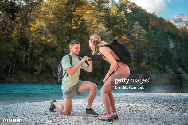 caucasian couple's proposal by the river - propose ring stock pictures, royalty-free photos & images