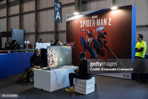 Fairgoers play Marvel's "Spider - Man 2" video game for Playstation during Milan Games Week 2023 at Rho Fieramilano on November 24, 2023 in Milan,...