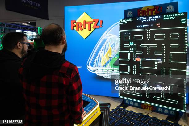 Two men play a vintage "Pac - Man" video game during Milan Games Week 2023 at Rho Fieramilano on November 24, 2023 in Milan, Italy. Milan Games Week...