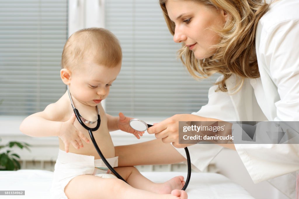 Pedriatrician playing with baby patient