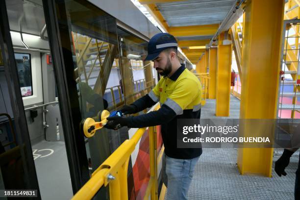 Technician of the Spanish company CAF checks the systems of a train at the maintenance and repair facility of Quito's Metro Line 1 near the...