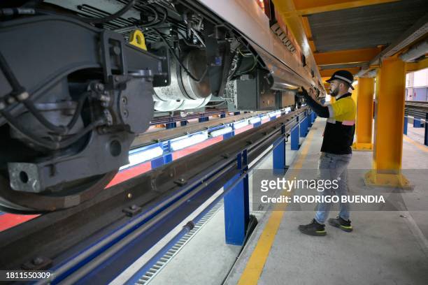 Technician of the Spanish company CAF checks the systems of a train at the maintenance and repair facility of Quito's Metro Line 1 near the...