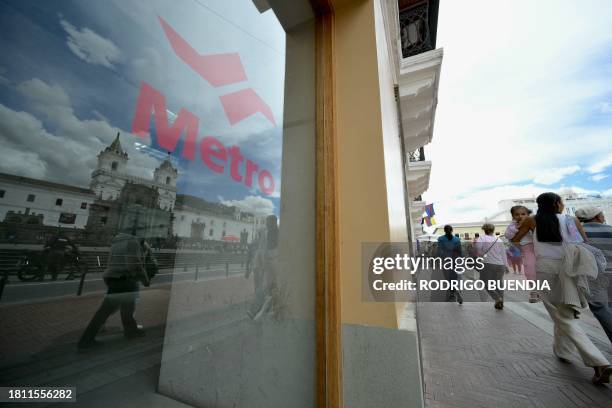 The San Francisco Church is reflected on a window of Quito's Metro Line 1 San Francisco subway station, in downtown Quito on November 28, 2023. After...