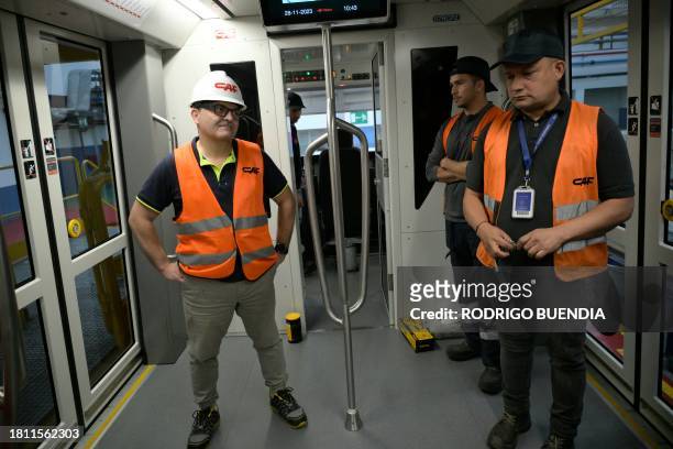 Technicians of the Spanish company CAF check the systems of a train at the maintenance and repair facility of Quito's Metro Line 1 near the...