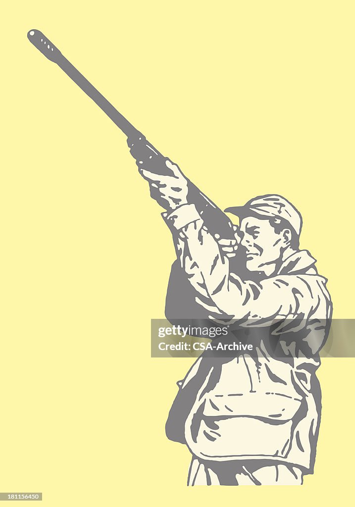 Hunter pointing gun in the air