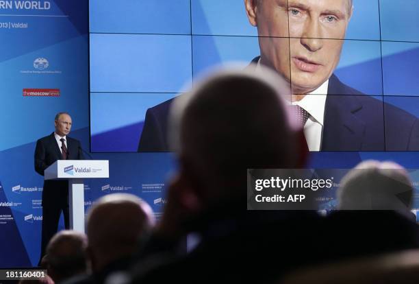 Russian President Vladimir Putin gestures as he speaks during a meeting of the Valdai International Discussion Club in Valdai on September19, 2013....