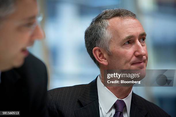 Daniel O'Day, head of the pharmaceutical division for Roche Holding AG, listens during an interview in New York, U.S., on Thursday, Sept. 19, 2013....