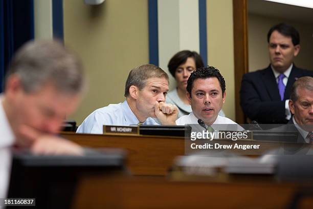 Rep. Jim Jordan and Rep. Jason Chaffetz confer with each other during a House Oversight Committee hearing entitled 'Reviews of the Benghazi Attack...