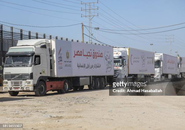 Aid and diesel trucks enter through the Rafah land crossing on November 24, 2023 in Rafah, Gaza. Palestinians who had taken refuge in temporary...