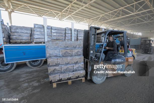 Aid and diesel trucks enter through the Rafah land crossing on November 24, 2023 in Rafah, Gaza. Palestinians who had taken refuge in temporary...