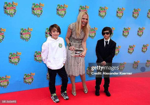 German TV presenter Sonya Kraus shows here purse, which is filled with chocolate, during the red carpet prior the Ferrero kinderTag 2013 event at...