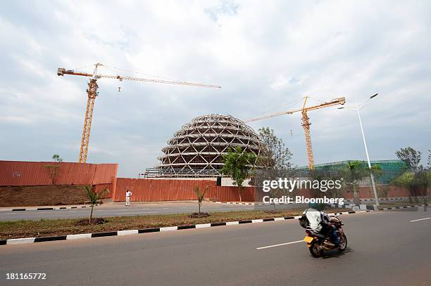 Construction cranes operate at the site of the Kigali Convention Center, part funded by the Bill and Melinda Gates Foundation, in Kigali, Rwanda, on...