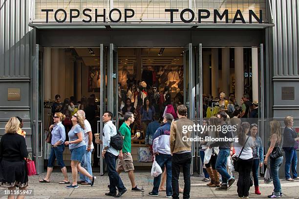 Pedestrians walk past a Topshop Topman store operated by Arcadia Group PLC, in the shopping district of Soho in New York, U.S., on Saturday, Sept....