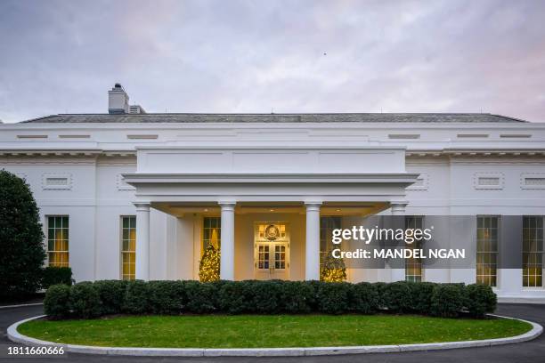 Christmas trees are seen outside of the West Wing of the White House in Washington, DC on November 29, 2023.