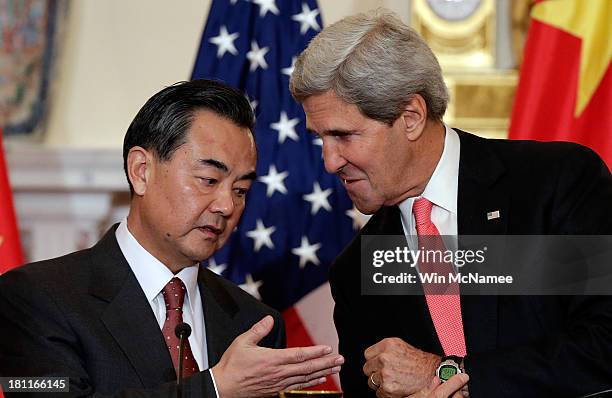Secretary of State John Kerry talks with Chinese Foreign Minister Wang Yi before the start of bilateral meetings at the State Department September...