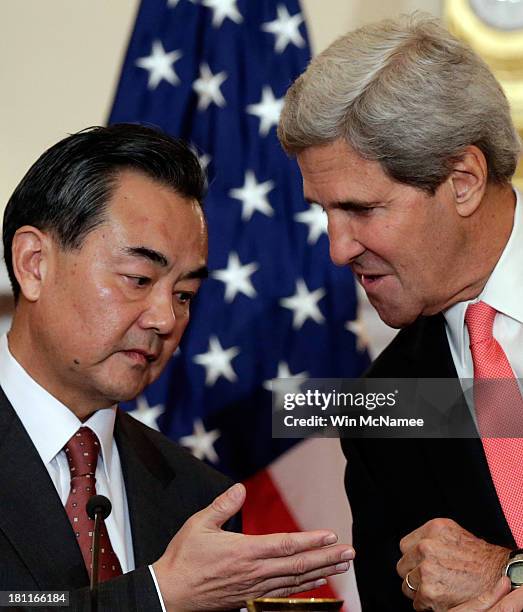 Secretary of State John Kerry talks with Chinese Foreign Minister Wang Yi before the start of bilateral meetings at the State Department September...