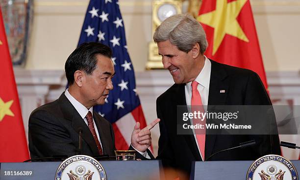 Secretary of State John Kerry talks with Chinese Foreign Minister Wang Yi before the start of bilateral meetings at the State Department September...