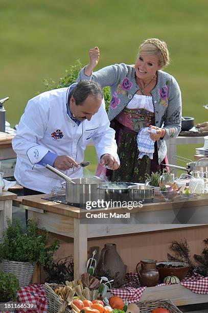 Johann Lafer and Andrea Kiewel during the recording of the TV Show 'ZDF Fernsehgarten' at Seiser Alm near Kastelruth on September 18, 2013 in...