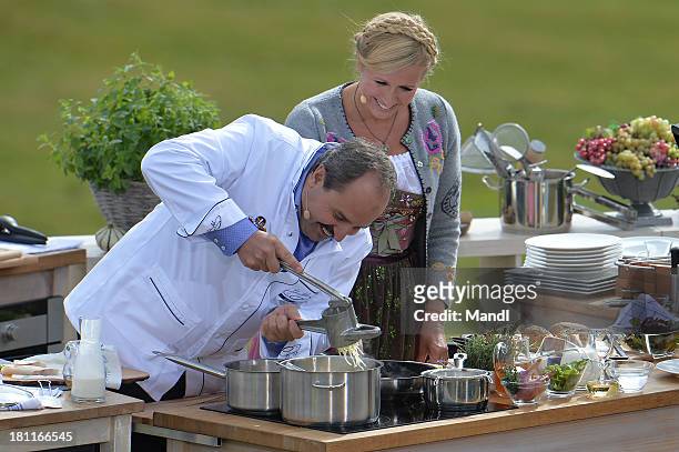 Johann Lafer and Andrea Kiewel during the recording of the TV Show 'ZDF Fernsehgarten' at Seiser Alm near Kastelruth on September 18, 2013 in...